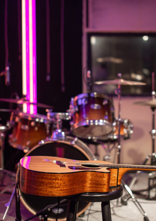 Acoustic guitar on the background of a recording Studio. Room for musicians rehearsals. The concept of musical creativity and show business.